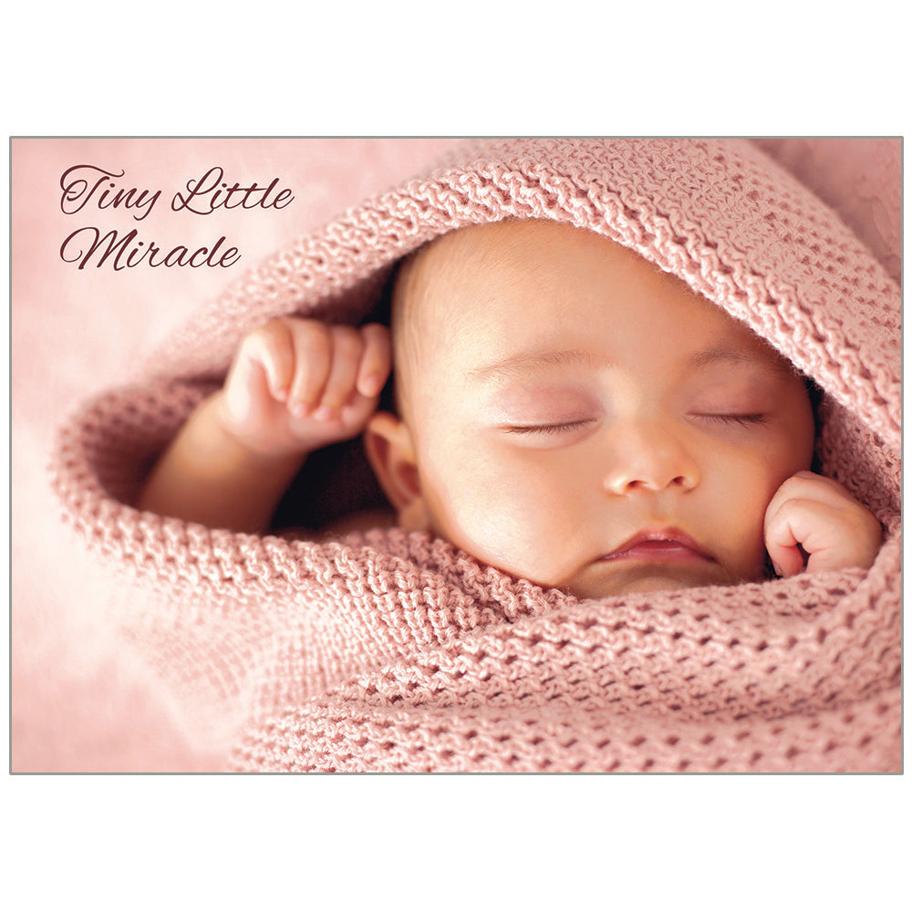 Newborn baby wrapped in pink fabric with 'Tiny Little Miracle' text