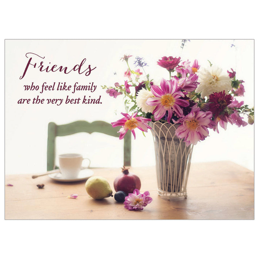 Floral arrangement with a vase on a table, featuring a quote about friends.